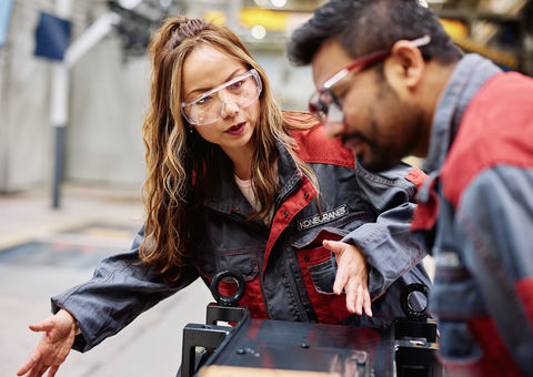 Woman and man working on Konecranes factory floor.  